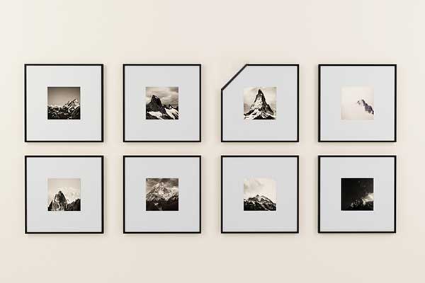 pictures on wall, one stands out to signify standing out in a growded market